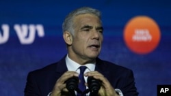 Israeli Prime Minister and the head of Yesh Atid party, Yair Lapid, speaks to his supporters after first exit poll results for the Israeli Parliamentary election at his party's headquarters in Tel Aviv, Israel, Nov. 2, 2022.