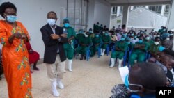 Uganda's health minister Dr. Jane Ruth Aceng, left, talks to doctors and nurses working at the isolation center, during their briefing at the Mubende referral hospital, Mubende, Uganda. The reappearance of the virus after three years has sparked fear in Uganda.