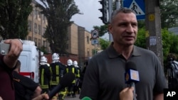 FILE - Kyiv mayor Vitali Klitschko speaks to the press at the scene of a residential building following explosions, in Kyiv, June 26, 2022.
