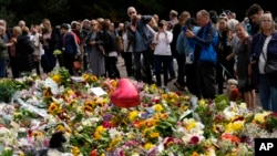 英國公眾在皇宮前擺滿獻花悼念女王，形成一片花海。