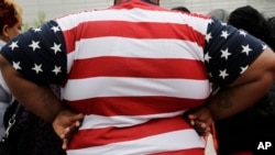FILE - In this May 8, 2014, file photo, an overweight person is seen in New York. As obesity rates climb in the U.S., more Americans say they’re following special diets compared to a decade ago. (AP Photo/Mark Lennihan, File)
