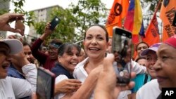 Supporters embrace opposition leader Maria Corina Machado during a rally in San Antonio, Venezuela, April 17, 2024. The Biden administration on Wednesday reimposed oil sanctions on Venezuela, admonishing Nicolas Maduro's efforts to consolidate his rule.