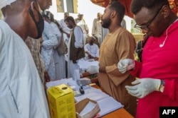 FILE - People queue at a medical laboratory to get tested for dengue fever in the eastern Gedaref state of Sudan, Sept. 22, 2023.