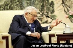FILE - Former U.S. Secretary of State Henry Kissinger speaks during a meeting with Chinese Foreign Minister Wang Yi (not pictured) at the Great Hall of the People in Beijing, China, Nov. 22, 2019. (Jason Lee/Reuters/Pool Photo)
