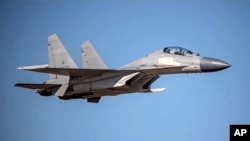 In this undated file photo released by the Taiwan Ministry of Defense, a Chinese PLA J-16 fighter jet flies in an undisclosed location.