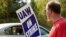Striking United Auto Workers member David Martin holds a sign outside the General Motors Customer Care and After-Sales facility in Brandon, Miss., Sept. 22, 2023. Unionized workers joined others in new nationwide walkouts as the labor standoff continued.