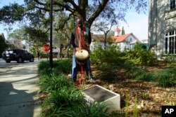 Ervin McDaniel Jr. plays his djembe, a West African drum, outside the Gaillard Performing Arts Center in Charleston, S.C., on Friday, Feb. 17, 2023. (AP Photo/Allen G. Breed)