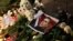 A portrait of Russian opposition leader Alexey Navalny is placed next to candles and flowers, as people attend a memorial event for Navalny, in front of the Russian embassy in Sofia, Bulgaria, Feb. 16, 2024. 