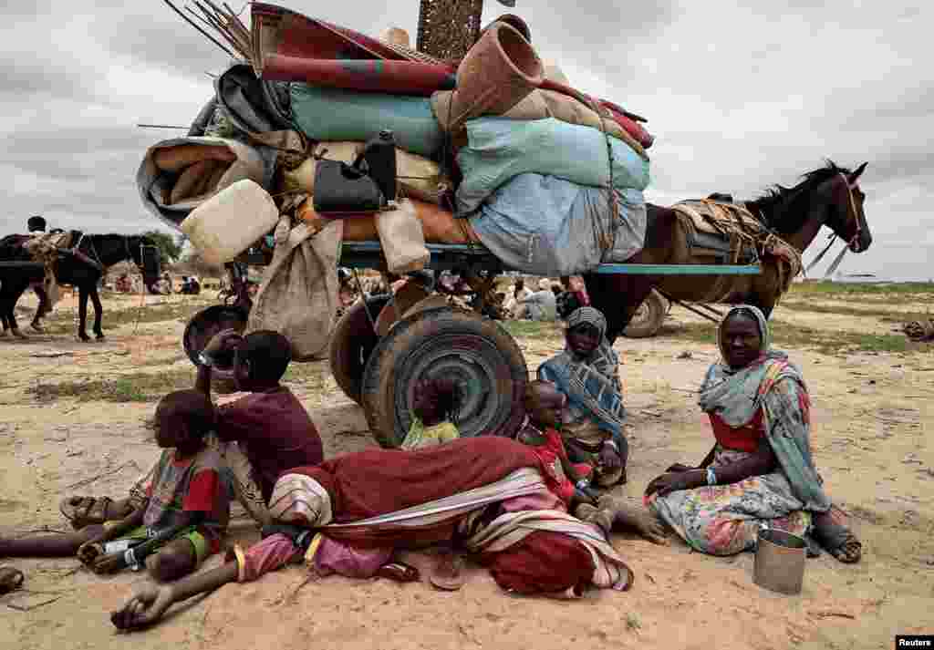 Sudanese family who fled the conflict in Murnei in Sudan's Darfur region, rest next to their belongings while waiting to be registered by UNHCR upon crossing the border between Sudan and Chad in Adre, Chad, July 26, 2023.