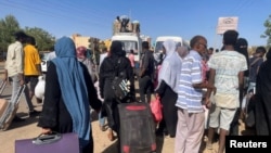 People gather at the station to flee from Khartoum during clashes between the paramilitary Rapid Support Forces and the army in Khartoum, Sudan, April 19, 2023. 