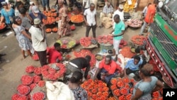 Pedestrians shop at the Mile 12 Market in Lagos, Nigeria, Feb. 16, 2024. 