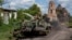 Ukrainian soldiers ride atop an armored vehicle in Ukraine's Sumy region, close to the country's border with Russia, Aug. 14, 2024.