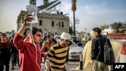 غزہ کے الاہلی العربی استپال کے باہر ایک شخص ایک مریض کو، جسے نس کے ذریعے دوا کی ٹیوب لگی ہوئی ہے، لے جا رہا ہے۔ 27 مارچ 2024