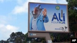 A defaced billboard of Gabon President Ali Bongo Ondimba is seen on an empty street in Libreville, Aug. 30, 2023. Mutinous soldiers said on state television that they had seized power and were overturning the results of the recent presidential election.