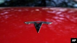 A Tesla logo on a vehicle on display in Austin, Texas, Feb. 22, 2023.