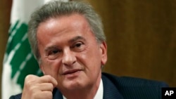 FILE - Riad Salameh, Lebanon's Central Bank governor, smiles during a press conference in Beirut, on Nov. 11, 2019. 
