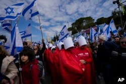 Israelis protest against plans by Prime Minister Benjamin Netanyahu's new government to overhaul the judicial system, outside the Knesset, Israel's parliament, in Jerusalem, Monday, Feb. 13, 2023. (AP Photo/Ohad Zwigenberg)