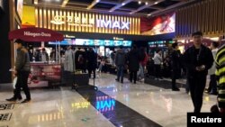 FILE - People wait for movie screening at an IMAX theatre inside the Wanda Plaza in Xinxiang, Henan province, China March 23, 2018. (REUTERS/Stella Qiu/File Photo)