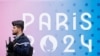 Un gendarme francés pasa junto al logotipo de los Juegos Olímpicos y Paralímpicos de París 2024 frente a la Asamblea Nacional en la capital de la Ciudad Luz, en Francia, el 2 de mayo de 2024.