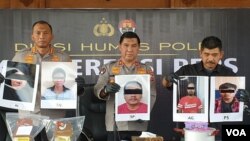 Polisi menunjukkan foto wajah tersangka yang ditangkap Densus 88 saat gelar kasus di Mapolresta Solo, Jumat (4/8). (Foto: VOA/ Yudha Satriawan)