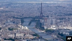 The Seine rivers flows though Paris, with the Eiffel Tower at center, in Paris, Tuesday, July 11, 2023. Heavy rains in Paris have dealt a blow to plans intended to test the readiness for swimmers to race in the River Seine at next year's Summer Olympics.