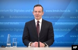 Volker Wissing, Federal Minister of Digital Affairs and Transport speaks on the use of e-fuels for new combustion engines even after 2035 and in the existing fleet in Berlin, Germany, Tuesday, Feb. 28, 2023. (Britta Pedersen/dpa via AP)