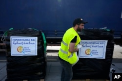FILE - A member of the World Central Kitchen prepares a pallet with the humanitarian aid for transport to the port of Larnaca from where it will be shipped to Gaza, at a warehouse near Larnaca, Cyprus, on March 13, 2024. (AP Photo/Petros Karadjias, File)