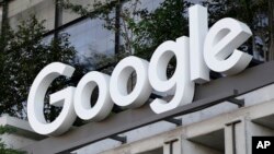 The Google sign is shown over an entrance to the company's new building in New York on Wednesday, Sept. 6, 2023.