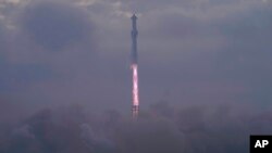 SpaceX's mega rocket Starship launches at dawn in the haze on it's third test flight from Starbase in Boca Chica, Texas, Thursday, March 14, 2024. (AP Photo/Eric Gay)