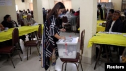 FILE - A woman casts her ballot during the general election in Dhaka, Bangladesh Dec. 30, 2018. 