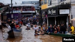 People are rescued after floods in Canoas, at the Rio Grande do Sul state, Brazil, May 5, 2024. 