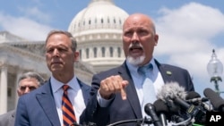 Republican Representatives Scott Perry and Chip Roy speak with reporters as members of the conservative House Freedom Caucus discuss the debt limit deal during a news conference on Capitol Hill in Washington, May 30, 2023.