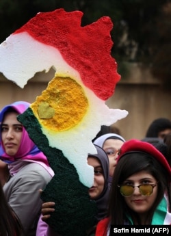 گەنجێکی شاری هەولێر نەخشەی هەرێمی کوردستانی هەڵگرتووە لە ڕۆژی ئاڵا لە ساڵی 2015.