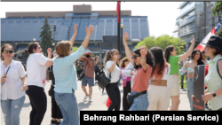Iranians dance in Toronto, Canada, on May 20, 2024, to celebrate the death a day earlier of Iranian President Ebrahim Raisi, who was reviled by opponents of Iran's authoritarian Islamist rulers. (Behrang Rahbari/VOA Persian)