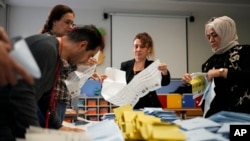 Election officials count ballots at a polling station in Istanbul, Turkey, March 31, 2024. 