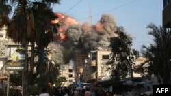 A ball of fire and black smoke rises moments after an Israeli airstrike targeted a residential building in the city of Bureij in the central Gaza Strip on June 3, 2024.