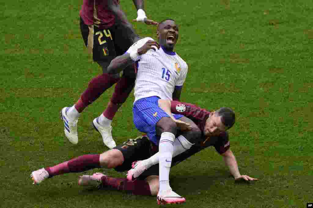 Marcus Thuram of France screams as he is tackled by Belgium's Jan Vertonghen during a round of sixteen match between France and Belgium at the Euro 2024 soccer tournament in Duesseldorf, Germany.