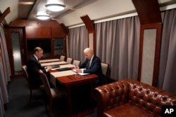 President Joe Biden sits on a train with National Security Advisor Jake Sullivan as he goes over his speech marking the one-year anniversary of the war in Ukraine after a surprise visit with Ukrainian President Volodymyr Zelenskyy, Monday, Feb. 20, 2023, in Kyiv. (AP Photo/ Evan Vucci)