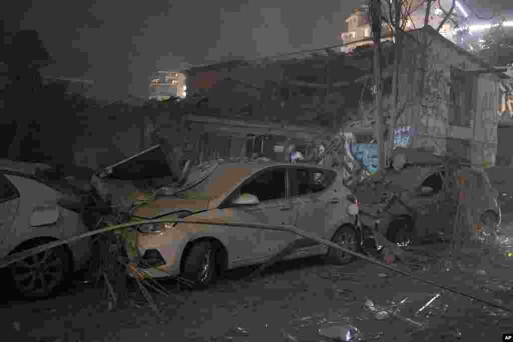 Cars and a building are seen after a rocket attack in Tel Aviv, Israel, Oct. 7, 2023.