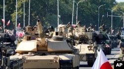 U.S.-made Abrams tanks purchased by Poland take part in a massive military parade to celebrate the Polish Army Day, commemorating the 1920 battle in which Polish troops defeated advancing Bolshevik forces, in Warsaw, Poland, Aug. 15, 2023. 