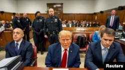 Former U.S. President Donald Trump sits in the courtroom at Manhattan Criminal Court with his lawyers in New York, April 25, 2024. (Mark Peterson/Pool via REUTERS)