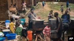 FILE - Community volunteers prepare meals for people who were displaced following heavy rains by tropical Cyclone Freddy at Manja displacement center in Blantyre, southern Malawi, March 16, 2023.