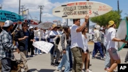 Locals march to protest the disappearance of foreign surfers in Ensenada, Mexico, May 5, 2024. Mexican authorities said Friday that three bodies were recovered in an area of Baja California near where two Australians and an American had gone missing.