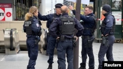 Police stand outside the Bibliotheque Francois-Mitterrand train station, where officers shot and injured a woman after she shouted 'Allahu Akbar' and 'You're all going to die,' in Paris, France, on Oct. 31, 2023.