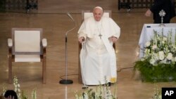 Pope Francis smiles as he arrives for a meeting with poor people and refugees in St. Elizabeth of Hungary Church in Budapest, Hungary, April 29, 2023.