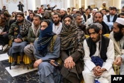 Relatives of grooms and brides attend a mass wedding ceremony at a wedding hall in Kabul, Afghanistan, Dec. 25, 2023.