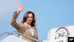 Vice President Kamala Harris waves while boarding Air Force Two as she departs Westfield-Barnes Regional Airport in Westfield, Massachusetts, July 27, 2024. 