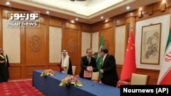 2023年3月10日，伊朗最高國家安全委員會秘書阿里‧沙姆哈尼(Ali Shamkhani)（右）在北京的會談結束後同中共中央政治局委員、中央外辦主任王毅握手。 照片最左邊是沙烏地阿拉伯國務大臣、內閣成員和國家安全顧問穆薩伊德·本·穆罕默德·艾班。