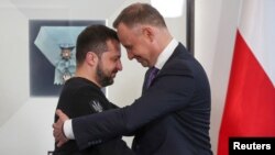 Poland's President Andrzej Duda greets Ukrainian President Volodymyr Zelenskyy at the Presidential Palace in Warsaw, Poland.