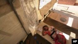 FILE - A cholera patient lies on a hospital bed in Harare, Zimbabwe, Nov. 19, 2023. 